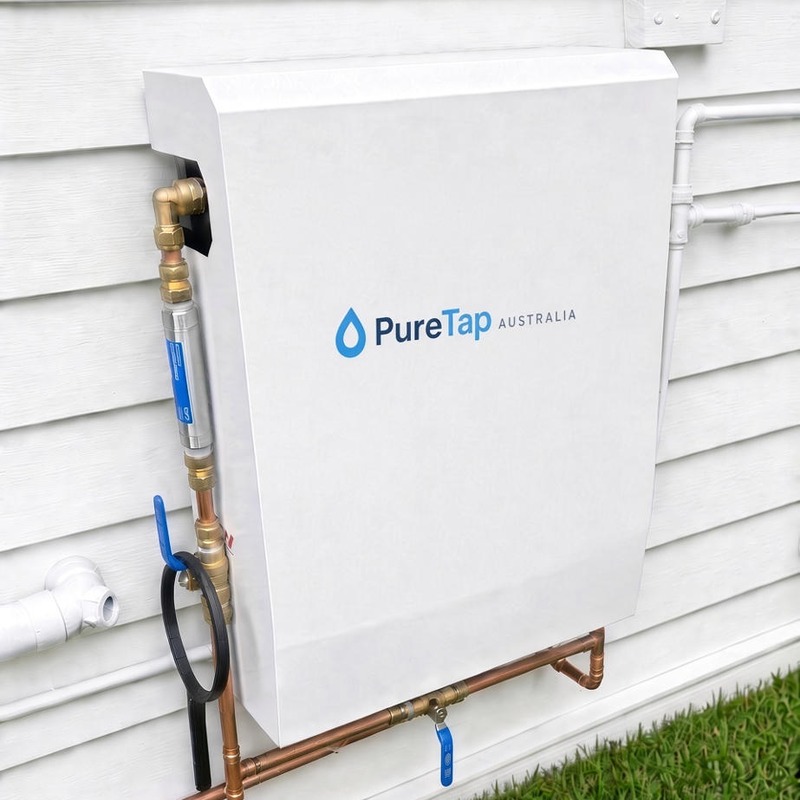 PureTap white whole house water filtration cabinet installed outside a home